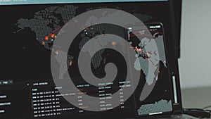 Global cyber attack with world map on mobile phone and computer screen. List of live attacks. Internet network