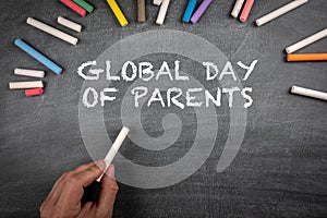 Global Day of Parents 1 June. Many colored pieces of chalk on a black chalkboard