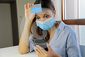 Global Economic Crisis Covid-19 Pandemic Coronavirus. Shocked desperate business woman with surgical mask looking on mobile phone