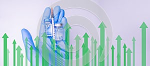 Global economy recovery after Covid 19 concept. Hands of a researcher in medical gloves takes shot from Coronavirus Vaccine vial