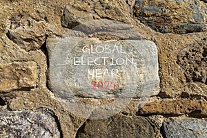 Global election year 2024 symbol. Concept words Global election year 2024 on beautiful big grey stone. Beautiful stone wall