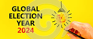 Global election year 2024 symbol. Concept words Global election year 2024 on beautiful yellow paper. Beautiful yellow background.