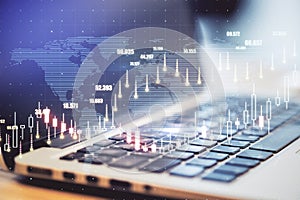 Global investing market concept with digital forex chart graphs and worl map on laptop background.