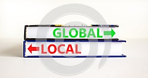 Global or local symbol. Concept word Global or Local on beautiful books. Beautiful white table white background. Business and