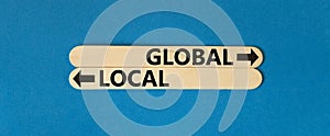 Global or local symbol. Concept word Global or Local on beautiful wooden stick. Beautiful blue table blue background. Business and