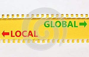 Global or local symbol. Concept word Global or Local on beautiful yellow paper. Beautiful white paper background. Business and