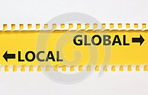 Global or local symbol. Concept word Global or Local on beautiful yellow paper. Beautiful white paper background. Business and