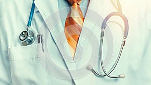 Global Medicine Healthcare Insurance Concept. Unrecognizable doctor with stethoscope, close-up front view toned image