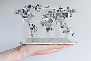 Global mobile devices and internet of things concept. Hand holding modern tablet or smart phone photo
