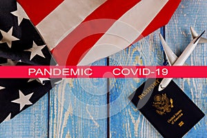 Global pandemic with coronavirus COVID-19 Travel tourism, emigration the USA American flag with U.S. passport and passenger model