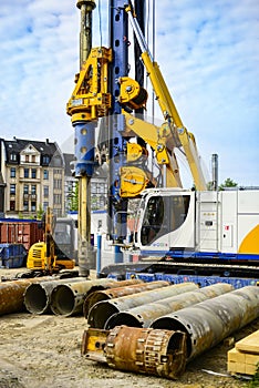 Global project of urban re-development: drilling machine at work on a building site