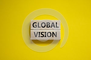 Global vision symbol. Wooden blocks with words `Global vision` on beautiful yellow background. Business and global vision concep