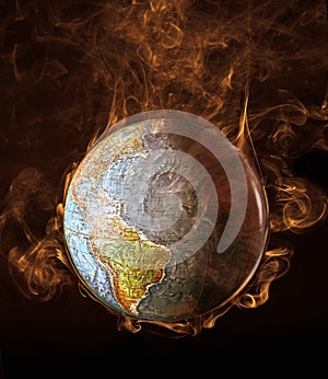 Global warming illustrated with flames surrounding  the earth,