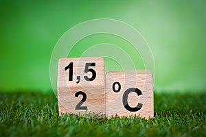 Global warming reduction icon. A rotating wooden cube with the symbol 2 C turning into 1.5 C Concept. limiting global warm