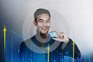 Globalization and Worldwide Business Marketing Concept. Happy Smiling Businessman holding a Transparent Blue World Globe in Hand.