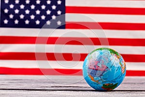 Globe on American flag background.