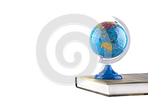 Globe on book.