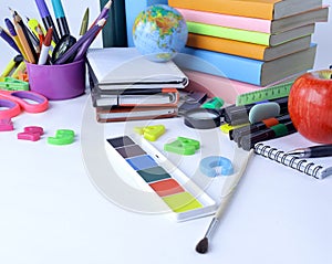 Globe, books and school supplies isolated on white background.photo with copy space