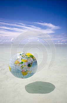 Globe floating in tropic sea