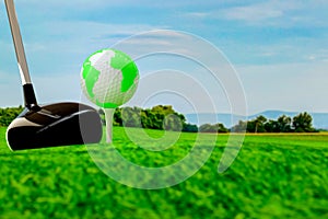 Globe on golf ball on green grass.