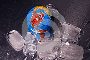 The globe lies in the ice. Planet earth. Global warming