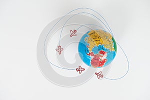 Globe model with air plane paper clip flying circle  on the white background for transport and travel concept