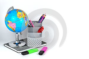 Globe, notebook stack and pencils. Accessories for schoolchildren and students. Back to the school concept.