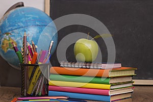 Globe, notebook stack and pencils. Schoolchild and student studies accessories.