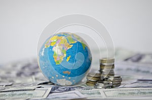 Globe over many American dollar banknotes.Economy background