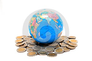 Globe on the pile of coins - isolated