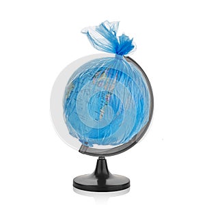 Globe of planet Earth dressed in a garbage plastic bag isolated on white.