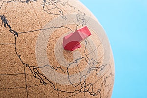 Globe with red arrow pin pointing at USA map blue background copy space. United states of America is business and finance hub