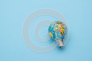 A globe-shaped light bulb on a light blue background