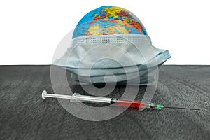 The globe and vaccination. The World epidemic of coronavirus. Earth Vaccination. An injection against the virus