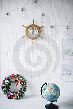 Globe on white wooden background with barometer