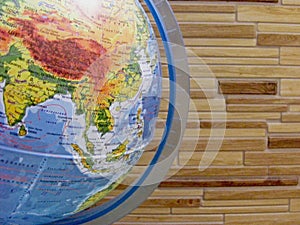 Close-up of globe on wooden background / concept card scool photo