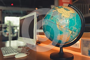 Globe world map and computer on desktop, Around the world travel