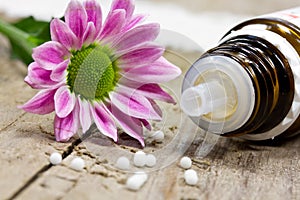 Globuli and pink flower