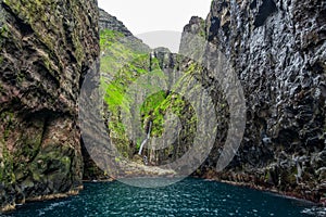 Gloomy cliffs near the ocean in Vestmanna photo