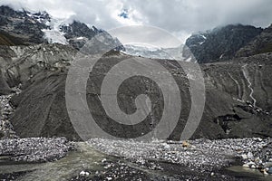 Gloomy cold landscape with mountain Tetnuldi and source of glacier river Adishchala in Svaneti Georgia