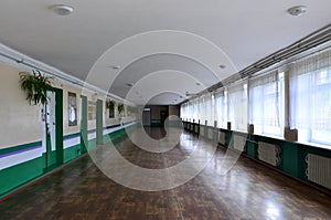 The gloomy corridor of a neglected public building. Public space in a poor residential high-rise buildin