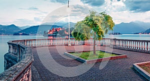 Gloomy evening cityscape of Stresa town. Wonderful summer view of Maggiore lake with Bella island on background, Province of Verba