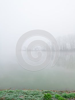 The gloomy landscape of the morning mist in the river valley.