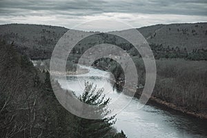 Gloomy landscape with a river in rocky hills