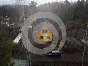 Gloomy landscape with yellow house