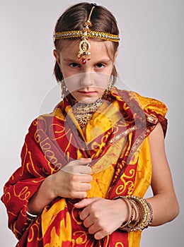 Gloomy little girl in traditional Indian clothing and jeweleries