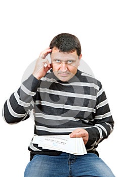 A gloomy man with a certificate of registration in the tax office