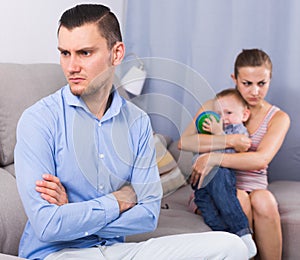 gloomy man and woman with crying son quarreled