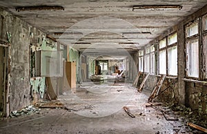 Gloomy school corridor with debris in Pripyat