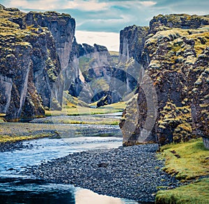 Gloomy summer view of Fjadrargljufur canyon and river. Splendid midnight sun scene of South east Iceland, Europe.